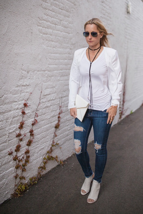 woman in white top and tattered jeans
