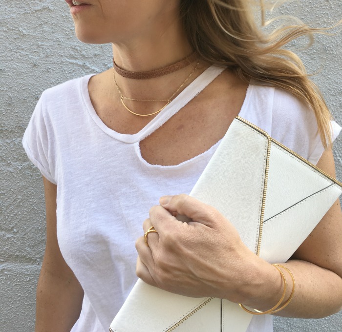 woman wearing white shirt and gold choker