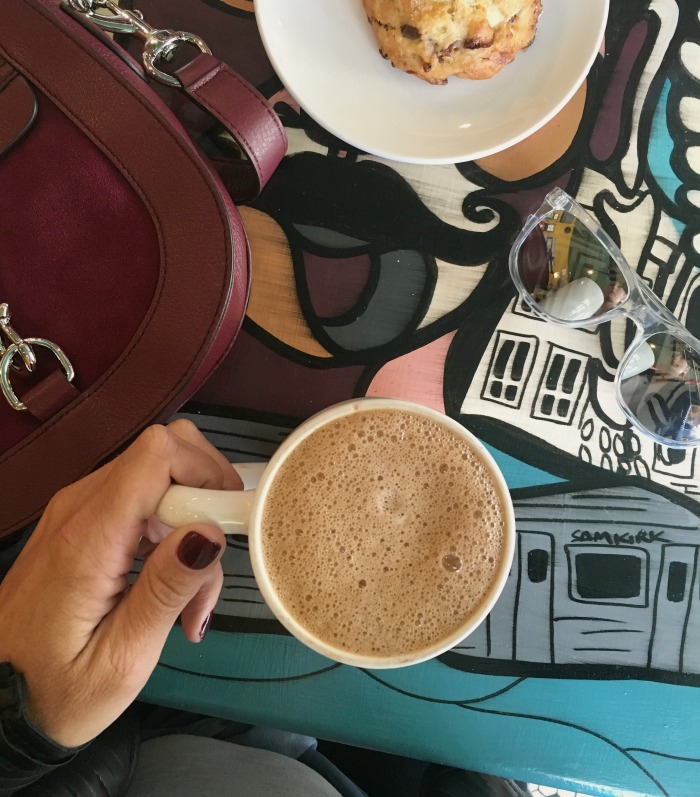 woman drinking coffee from Off the Beaten Path one of the best Chicago area coffee shops