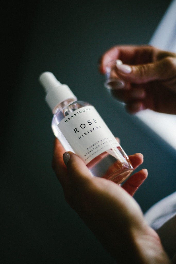 woman's hands holding herbivore product for blogging about beauty
