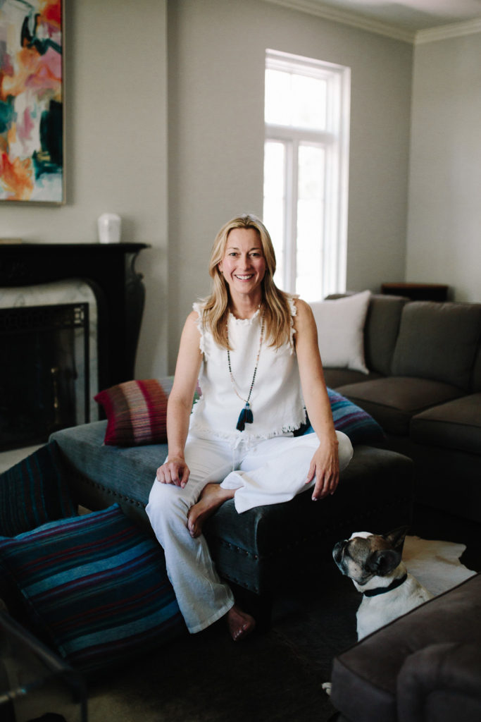woman sitting on blue couch for Decor Trends 