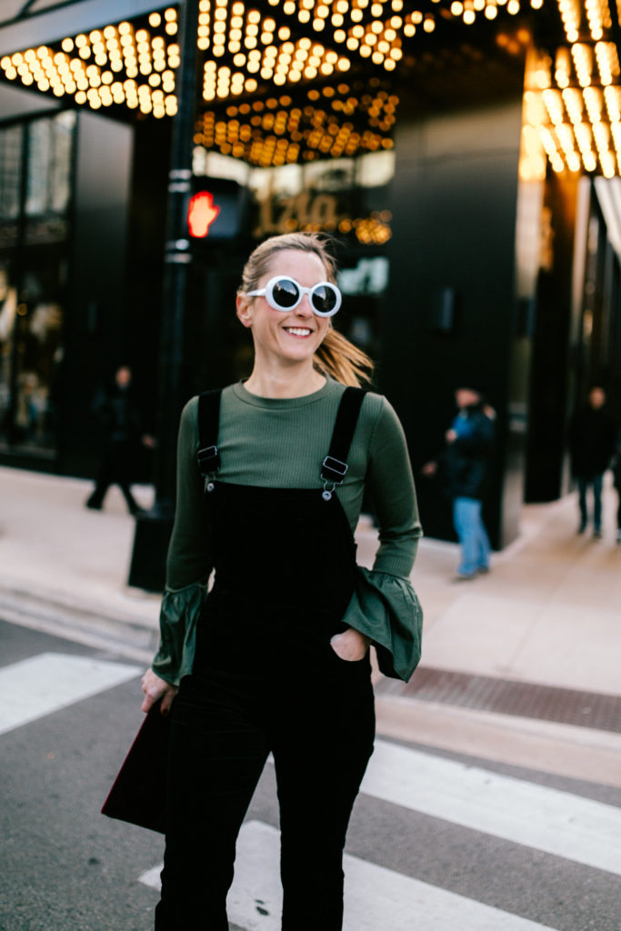 woman wearing green long sleeves and black jumper 