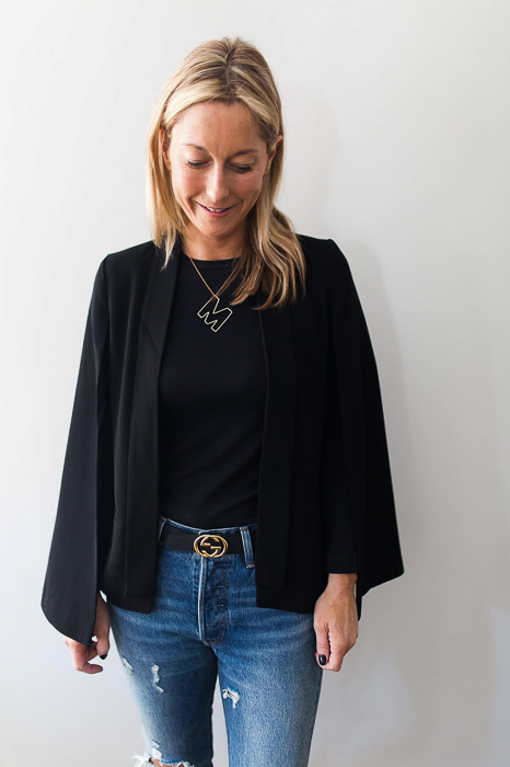 woman wearing Black cape with arm holes elevates a basic look