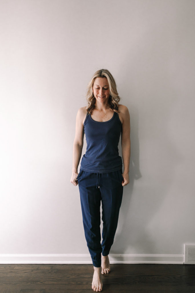 woman wearing navy tank with loose fitting navy rayon joggers for travel attire