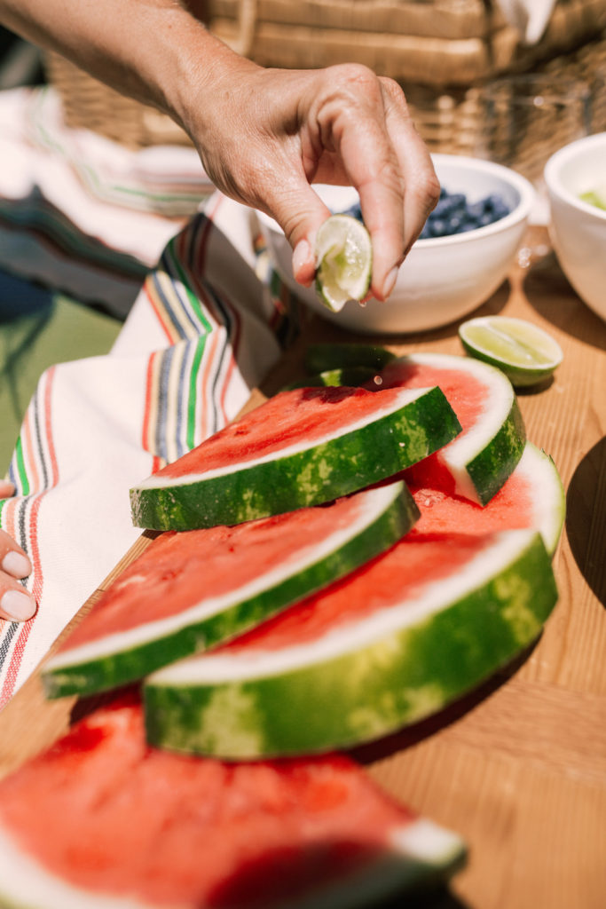 Fresh lime juice squeezed over watermelon slices 