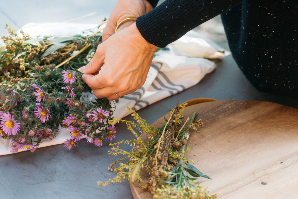 Then, get to cutting and playing around with various colors. Instead of adding them to a vase, I like to arrange them flat on a wood board.