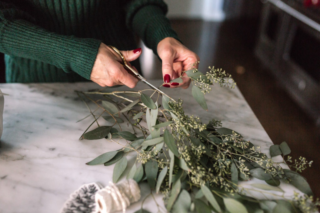 Cut a piece of fresh eucalyptus (Trader Joe's always has this in stock) and insert in between the tie at top.